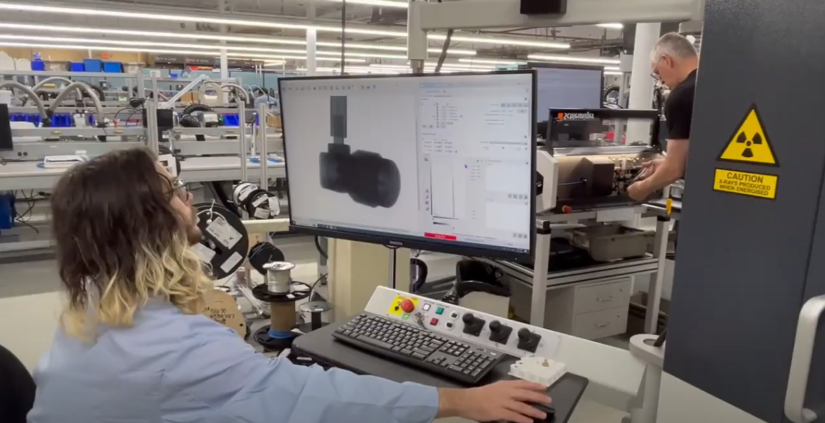 A Delta team member viewing a part in the x-ray machine.