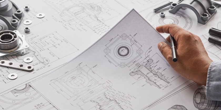 A close-up of an engineer reviewing design drawings.