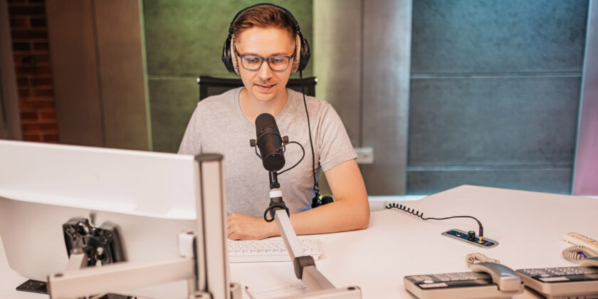 A radio host using a microphone to broadcast.