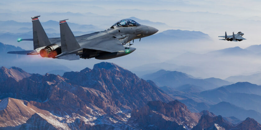 US military fighter jets flying over mountains.