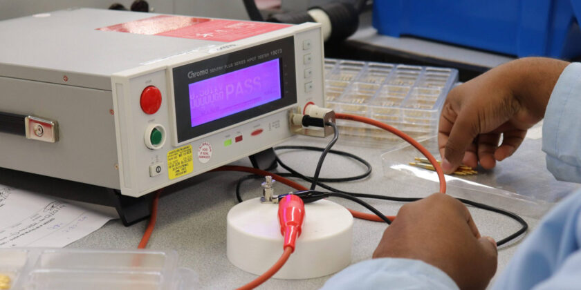 A Delta team member conducting a test on parts.